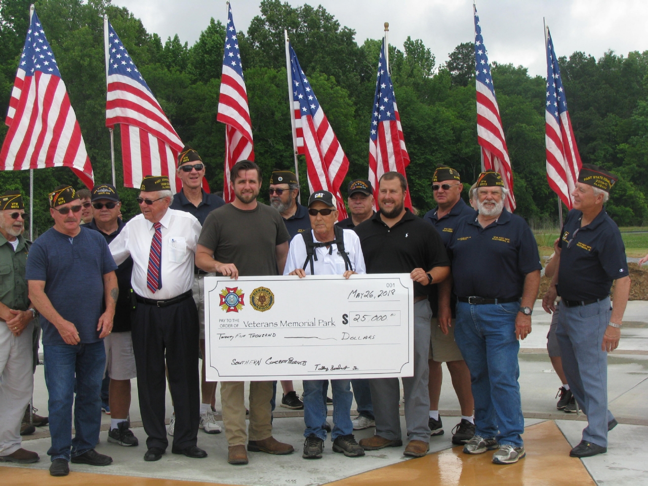 Members of VFW Post 6073 accept a Platinum donation to the Veterans Memorial Park during a celebration for the start of installation of the first inscribed brick pavers that have been purchased as a fund raiser for the park.